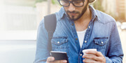 Man in hat looking at cell phone